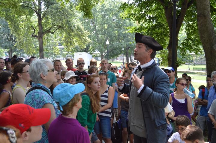 Guide speaking to crowd